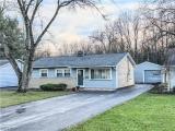 Single story home with a front yard and a garage