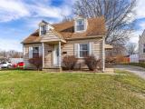 Cape cod home with a front lawn